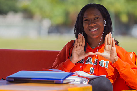 Female Student Throwing Up the U